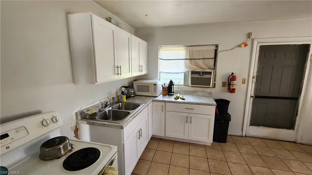 a kitchen with a refrigerator sink and cabinets