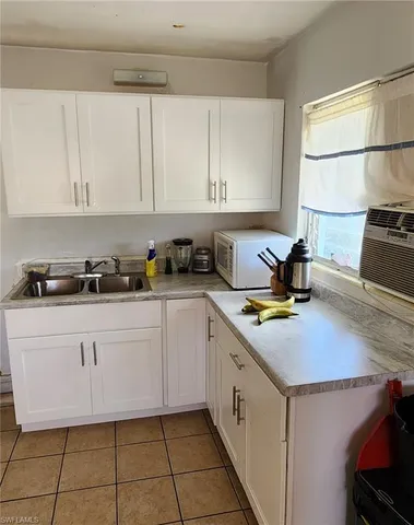 a kitchen with a white cabinets and white appliances