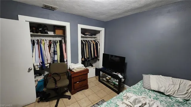 a bedroom with furniture and a flat screen tv