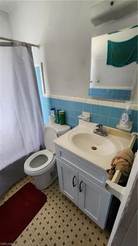 a bathroom with a sink a toilet and mirror
