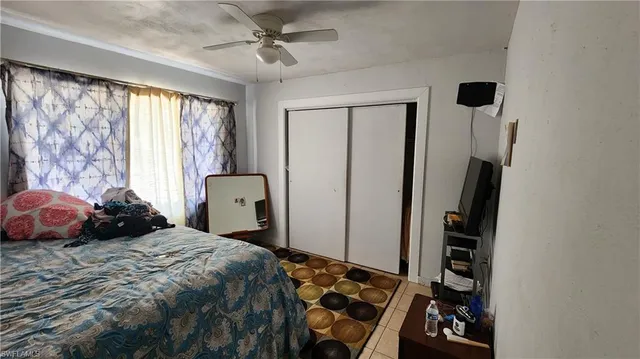 a bedroom with bed and a window