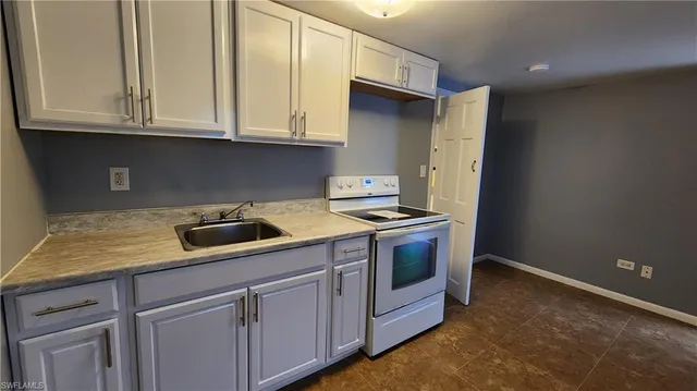 a kitchen with granite countertop cabinets washer and dryer