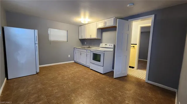 a kitchen with a stove and a refrigerator