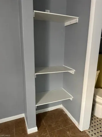 a room with wooden floor and a window