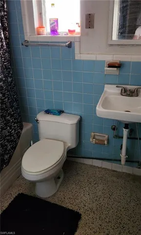 a bathroom with a toilet and a sink