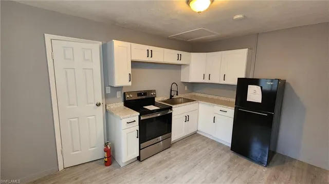a kitchen with a stove and a refrigerator