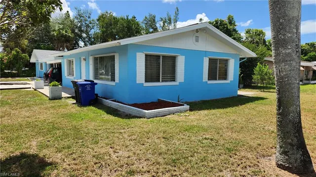 a view of house with backyard outdoor seating area and barbeque oven