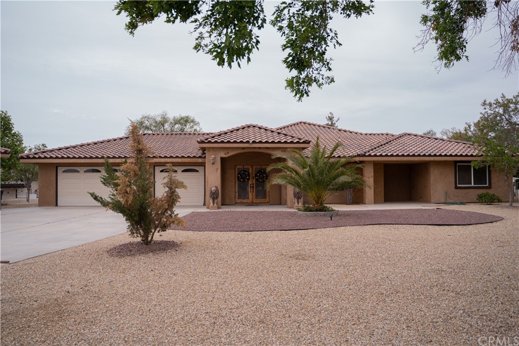19791 Symeron Road Apple Valley, CA 92307 - Photo 1 of 1 front view of a house with glass windows and a yard
