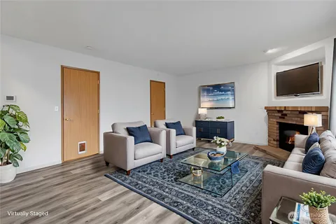 a living room with fireplace furniture and a flat screen tv