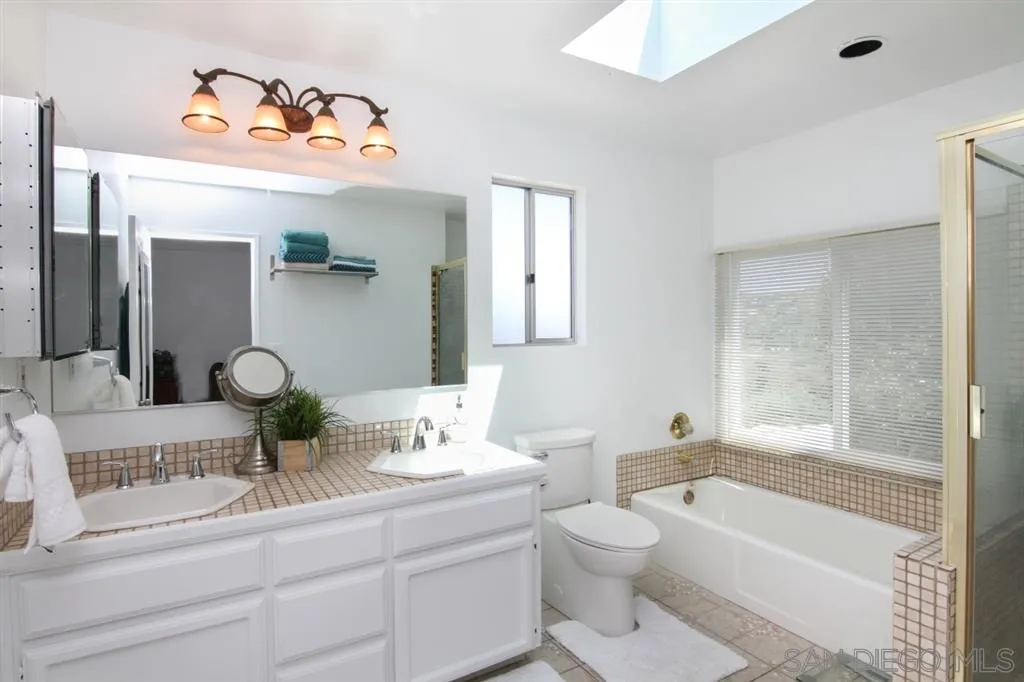 800 South Grade Road Alpine, CA 91901 - Photo 16 of 25 a bathroom with a toilet a sink and a bathtub