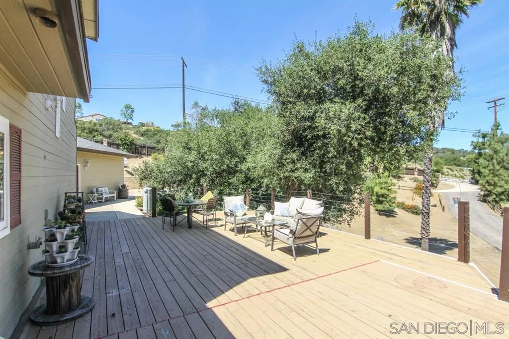 800 South Grade Road Alpine, CA 91901 - Photo 18 of 25 a view of a patio with table and chairs with wooden floor and fence