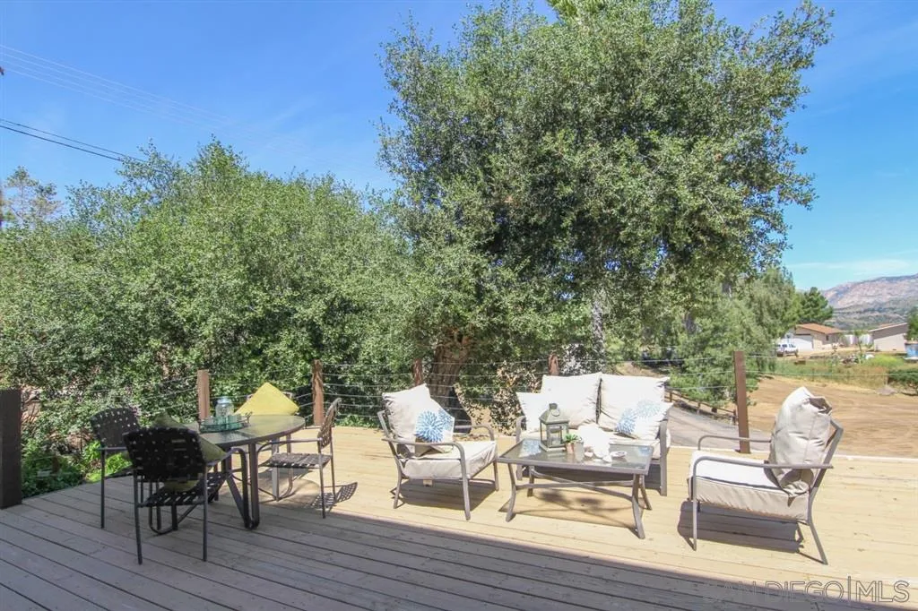 800 South Grade Road Alpine, CA 91901 - Photo 19 of 25 a view of patio with table and chairs and couches with wooden floor and fence