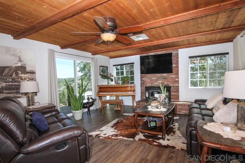 800 South Grade Road Alpine, CA 91901 - Photo 3 of 25 a living room with furniture a fireplace a flat screen tv and a large window