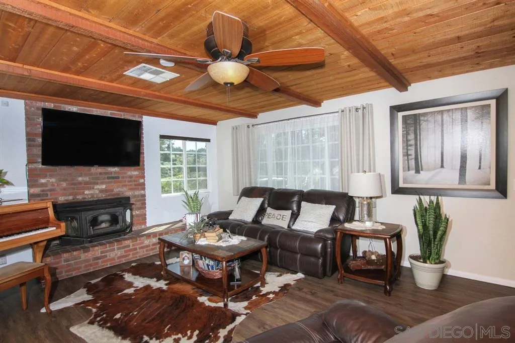 800 South Grade Road Alpine, CA 91901 - Photo 4 of 25 a living room with furniture a flat screen tv and a fireplace