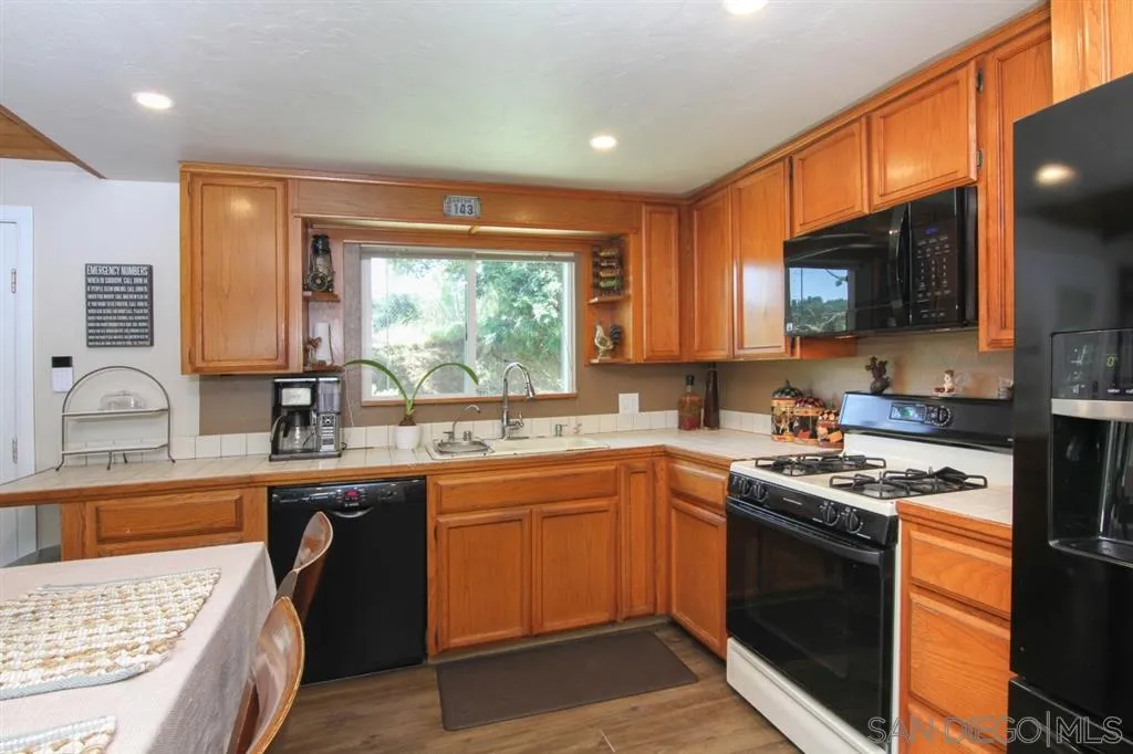 800 South Grade Road Alpine, CA 91901 - Photo 8 of 25 a kitchen with stainless steel appliances granite countertop a sink stove and refrigerator