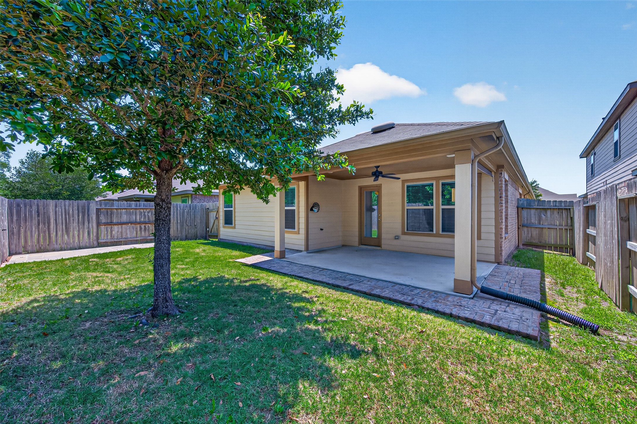 2754 Cayden Creek Way Conroe, TX 77304 - Photo 33 of 40 a view of a house with backyard and wooden fence