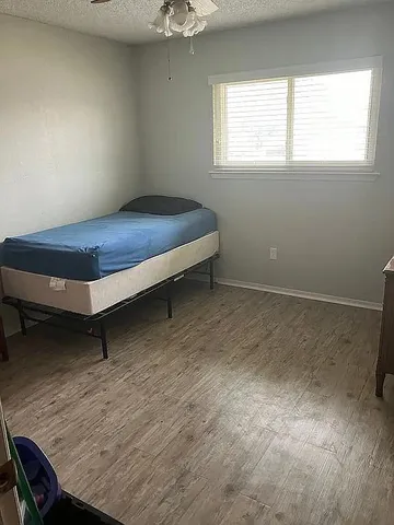 a room with a bed and window