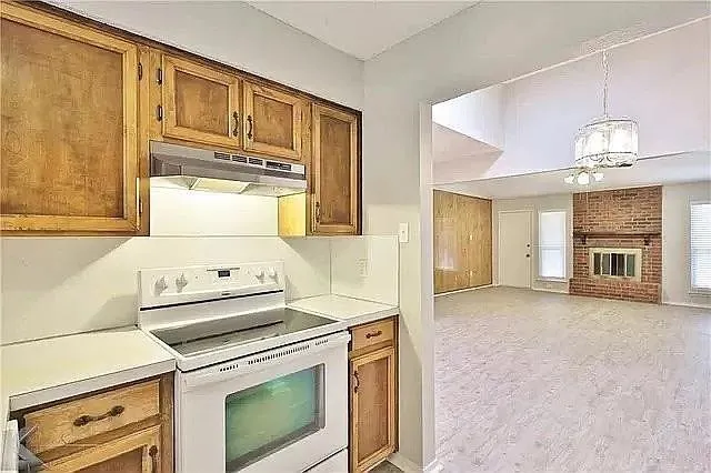 a kitchen with a stove and a refrigerator
