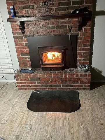 a room with wooden floor and flat screen tv