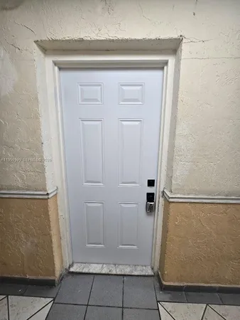 a kitchen with a refrigerator a stove top oven and cabinets