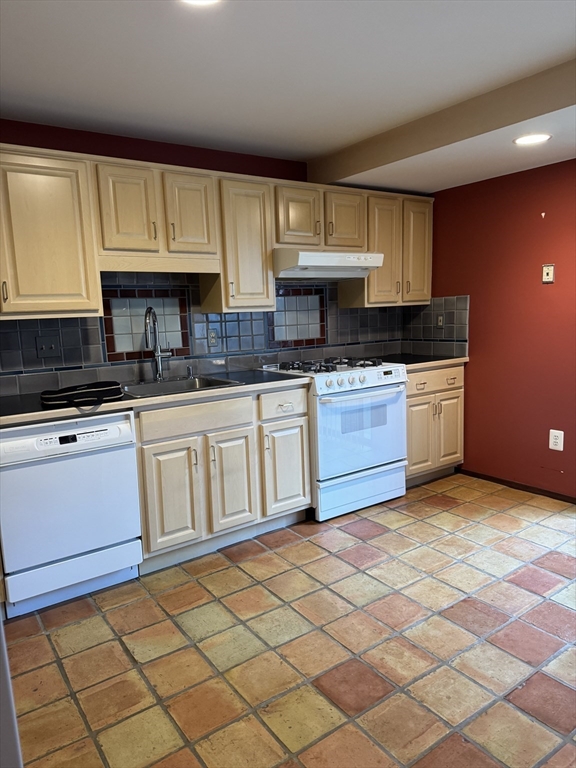 445 Old Stone Brook, Unit 445 Acton, MA 01718 - Photo 2 of 16 a kitchen with stainless steel appliances granite countertop a sink and cabinets