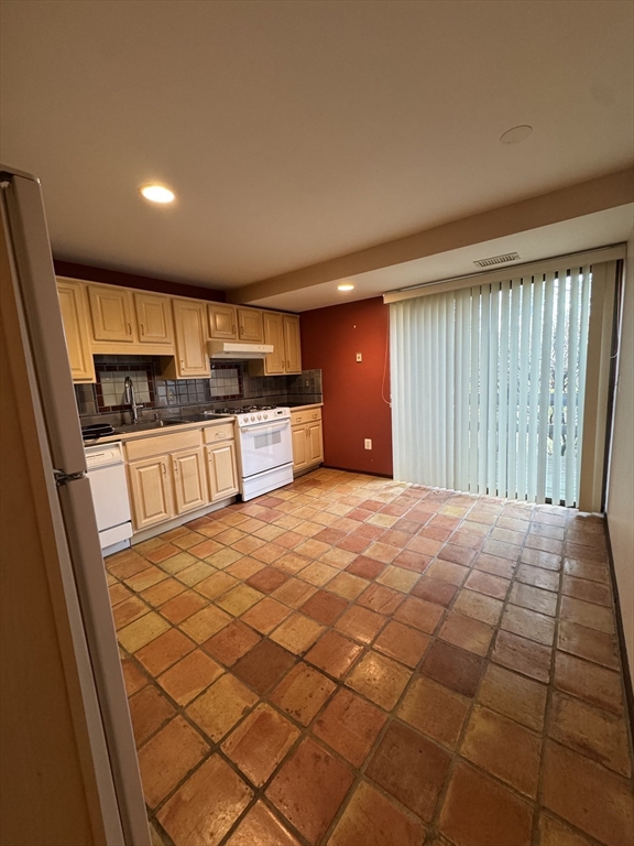 445 Old Stone Brook, Unit 445 Acton, MA 01718 - Photo 3 of 16 a large kitchen with a sink and dishwasher a refrigerator with wooden floor