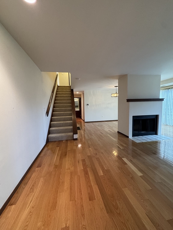 445 Old Stone Brook, Unit 445 Acton, MA 01718 - Photo 7 of 16 a view of empty room with wooden floor