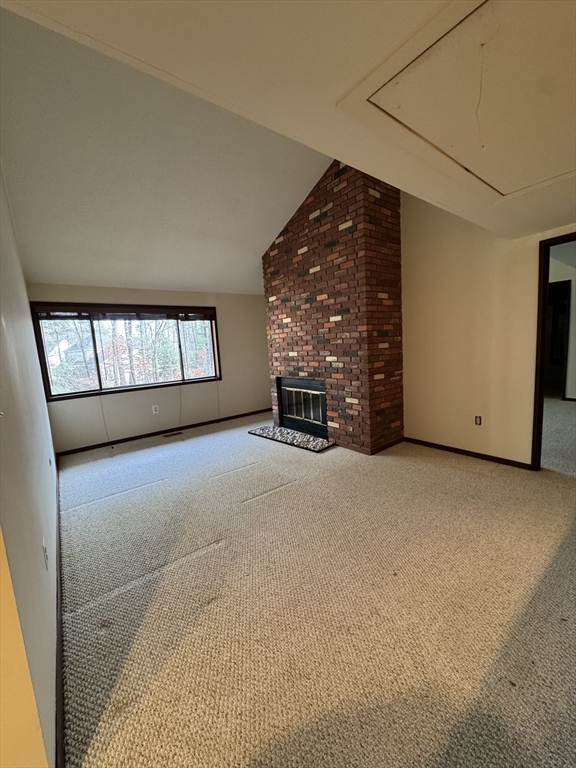 445 Old Stone Brook, Unit 445 Acton, MA 01718 - Photo 8 of 16 a view of an empty room with a fireplace