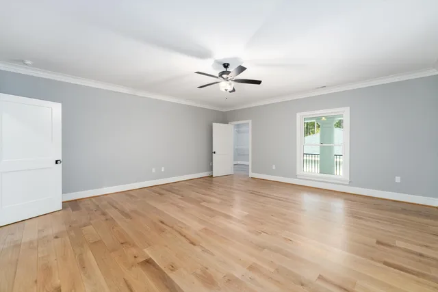 a view of an empty room with a fireplace and a window