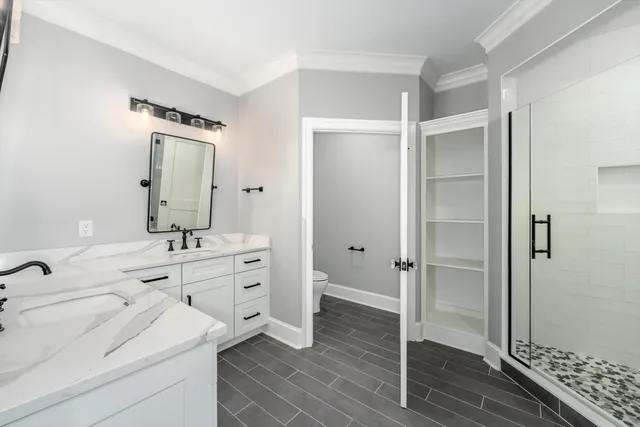 a large kitchen with kitchen island a sink dishwasher a dining table and chairs with wooden floor