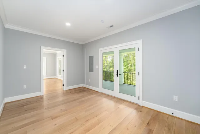 a view of a house with a big yard and large trees