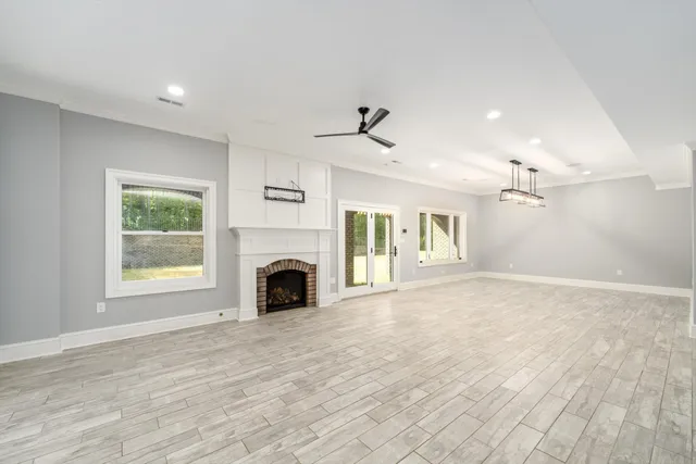 a view of a big building with a big yard and large trees