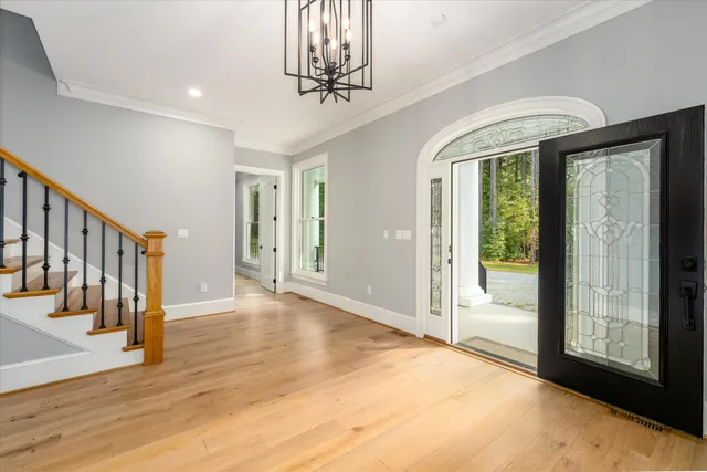 a view of an empty room with a fireplace and a window