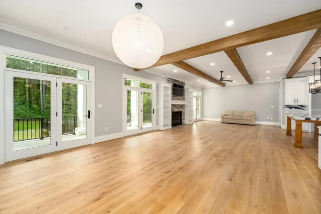 a kitchen with kitchen island a stove a sink and a wooden floors