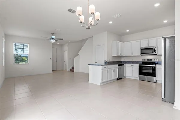 a view of kitchen with sink microwave and cabinets