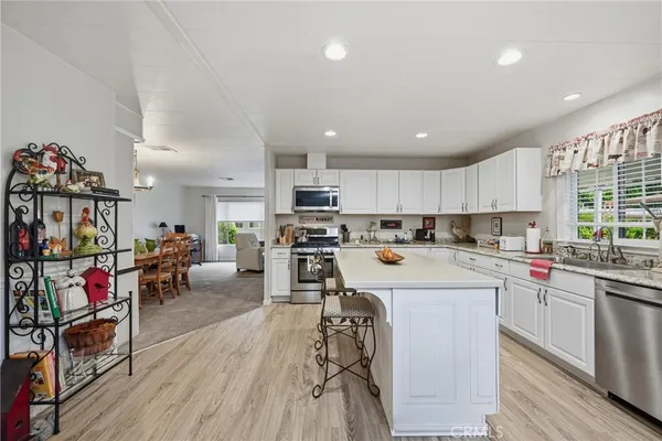 a kitchen that has a lot of cabinets in it and appliances