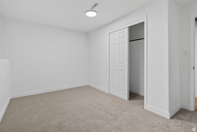 489 Owens Street Layton, UT 84041 - Photo 17 of 25 Unfurnished bedroom with light carpet and a closet