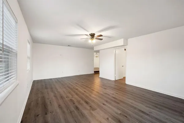 wooden floor in an empty room with a window