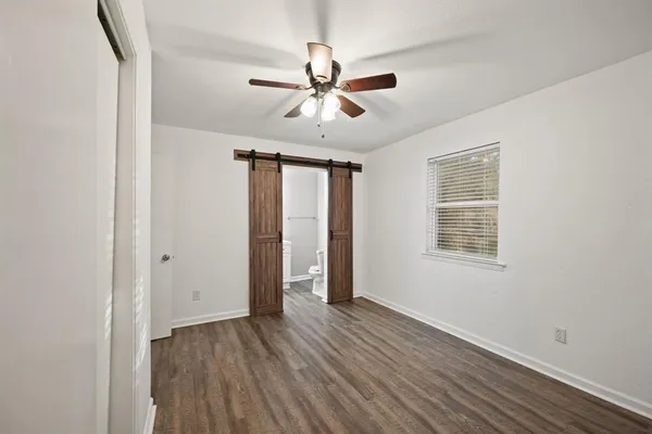 a view of walk in closet with wooden floor