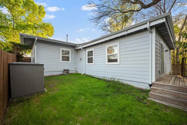a view of a house with a yard and tree