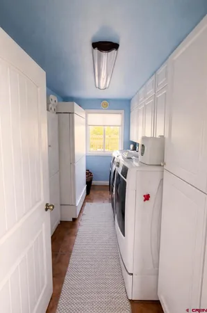 a utility room with closet dryer and washer