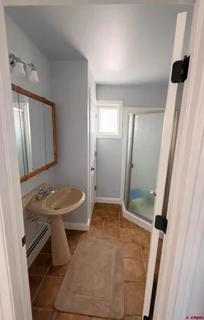 a bathroom with a sink toilet and mirror