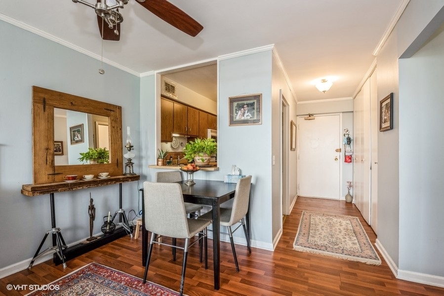 5415 North Sheridan Road, Unit 1015 Chicago, IL 60640 - Photo 4 of 10 a view of a dining room with furniture window and wooden floor