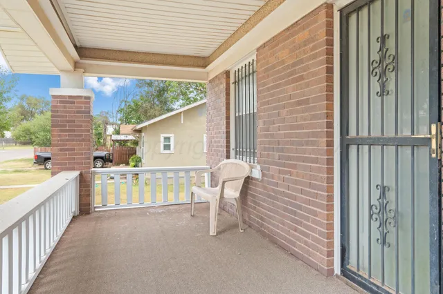 a view of a balcony with furniture