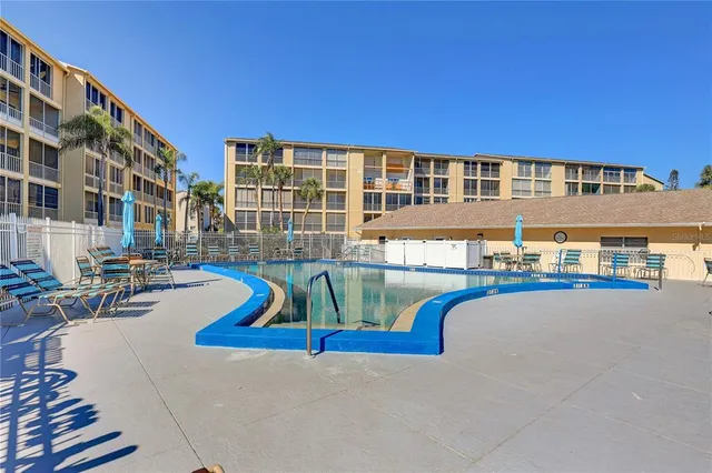 a front view of a house with swimming pool and porch