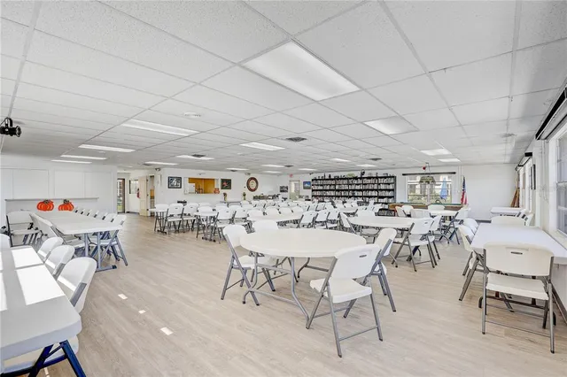 a view of a dining room with furniture and a kitchen