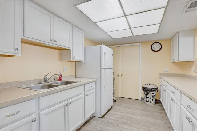 a kitchen with a sink and a refrigerator