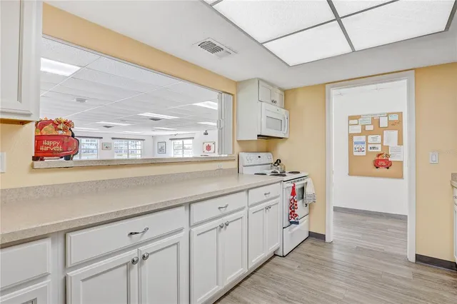a kitchen with stainless steel appliances a sink and cabinets