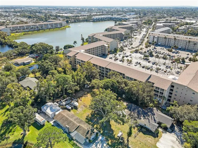 an aerial view of lake and residential houses with outdoor space