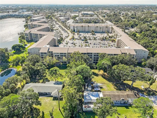 an aerial view of residential houses with outdoor space and swimming pool